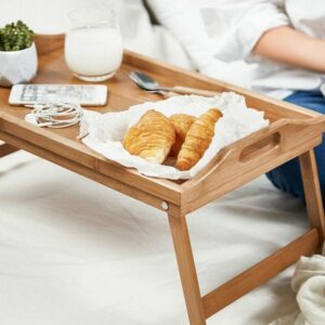 a men & women is trying Bamboo Breakfast Bed Tray Table at reconnect